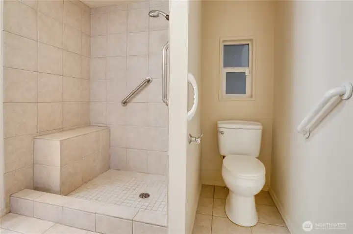 A large walk-in shower with a built-in bench adds convenience—and the recently updated water heater ensures plenty of hot water.