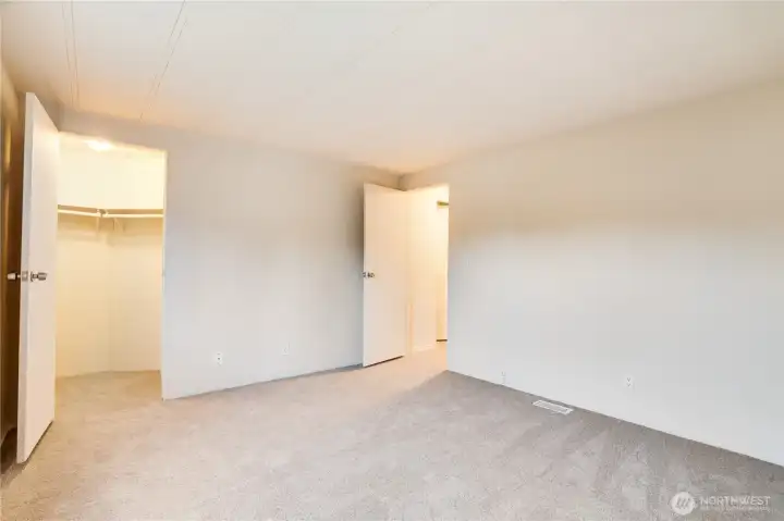 Another view shows the walk-in closet—freshly painted like all closets in the home. So much storage throughout!