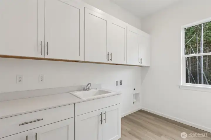 ***Not Actual Home*** Laundry room with cabinets and large sink