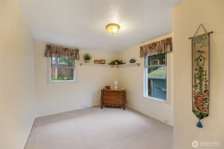 Main floor bedroom with potential to easily capture space for a walk in closet.