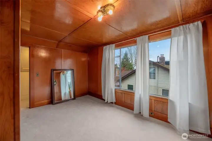 Upper bedroom with timeless wood décor. Large picture window allows for plenty or light in the daytime. Two closet spaces for you to enjoy.