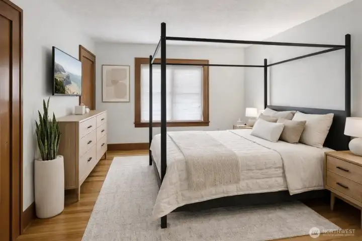 (Virtually Staged) The main floor features a spacious primary bedroom with an attached bath, offering comfort and convenience all on one level.