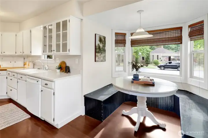 A charming breakfast nook offers the perfect spot to enjoy morning coffee or casual meals surrounded by natural light.