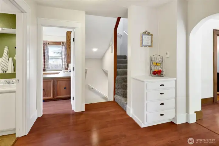 The stairwell leads to three upstairs bedrooms, one of which is really a spacious bonus room that offers plenty of flexibility for work, play, or guests if not used as a bedroom.