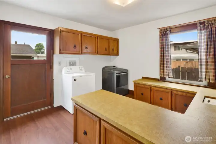 This versatile laundry room not only offers exterior access but was also used as a sewing room, complete with ample cabinets and counter space.