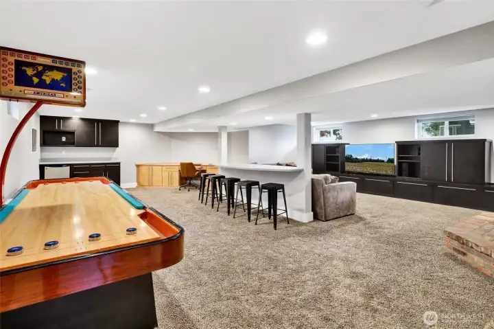 Quite possibly the favorite spot in the entire home is the basement! Enjoy shuffleboard, a dry bar, desk space, and a spacious media room for fun and relaxation.