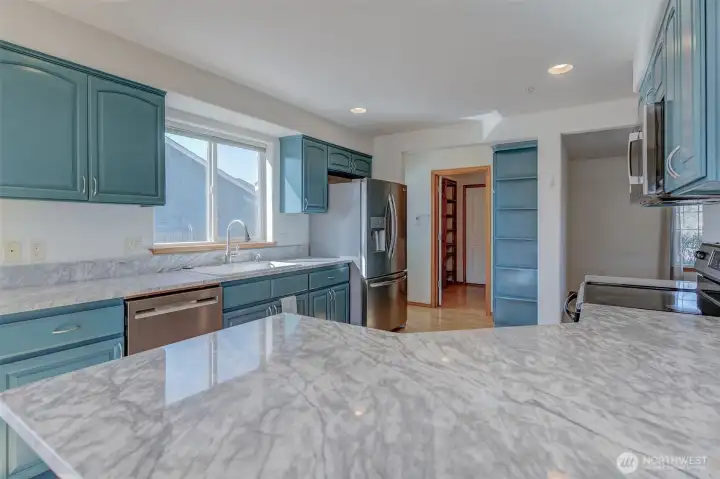 Granite kitchen counters paired with painted cabinets create a modern farmhouse aesthetic buyers love.