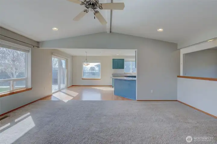 Bright living room featuring large windows, abundant natural light, and cozy propane fireplace for year-round comfort.