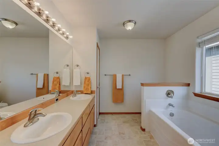 Primary bathroom with double sinks provides convenience and space for busy mornings.