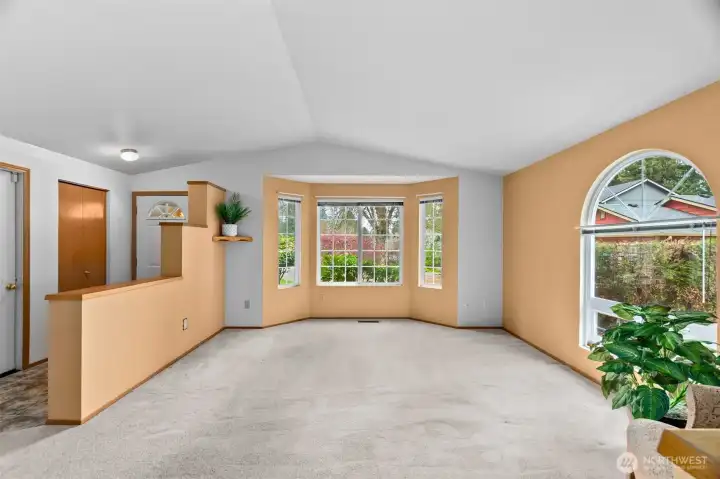 Lovely vaulted living room garage door off to the left