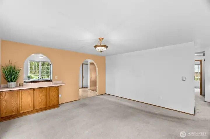 Dining room view towards arched entry to kitchen.