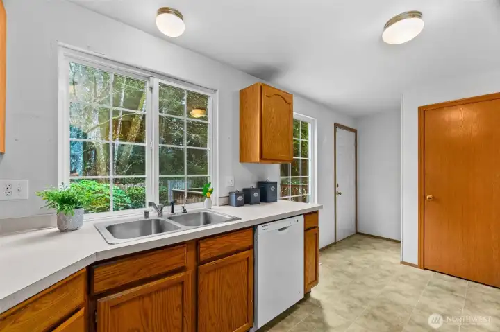 Kitchen view of rear door to deck and pantry door on the right.