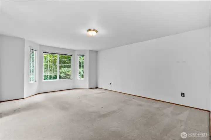 Primary bedroom has ample space for a king sized bed with nightstands.