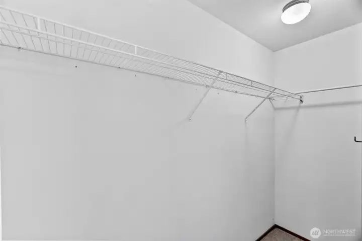 Huge primary bedroom closet wraps around for extra storage.