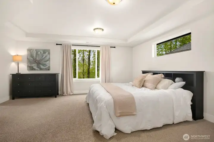 Primary bedroom on upper level overlooking tranquil greenbelt!