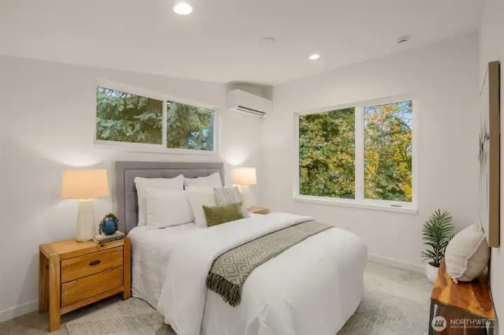 The primary bedroom lives large, the tall ceilings add volume