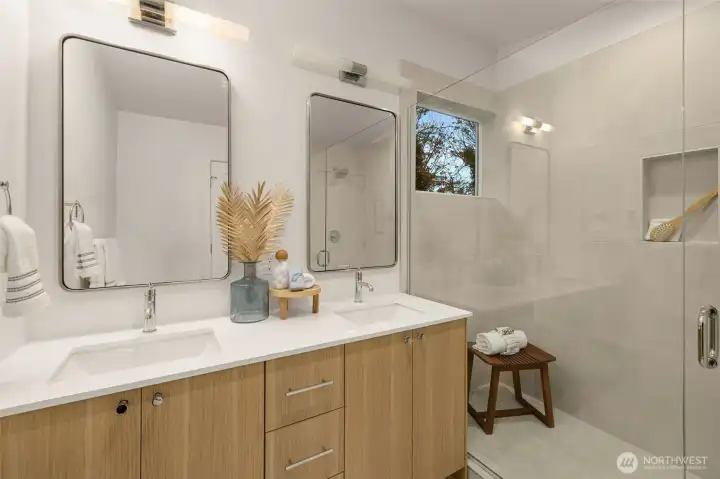 Attached, a luxury bathroom— features full tile surround, quartz countertops, and a dual vanity