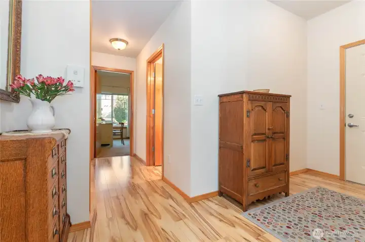 On the right is the front entry.  The open door on the right is the guest bathroom.  Open door straight ahead is bedroom #1 or office.