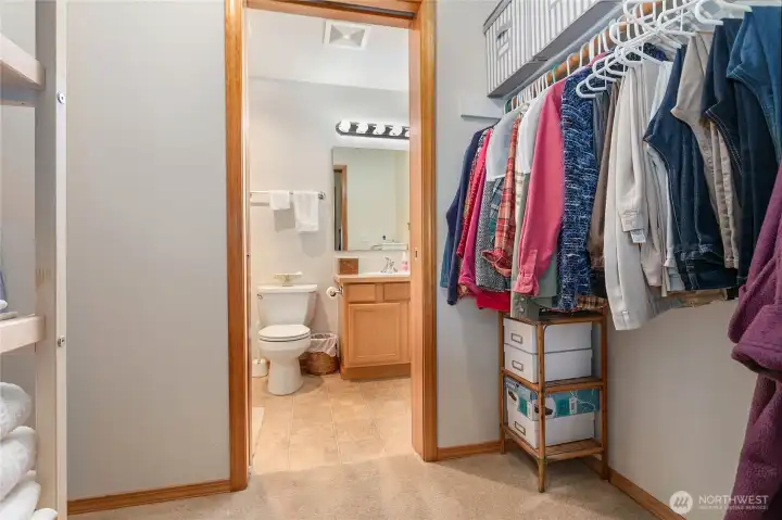 Walk through closet into primary bathroom.