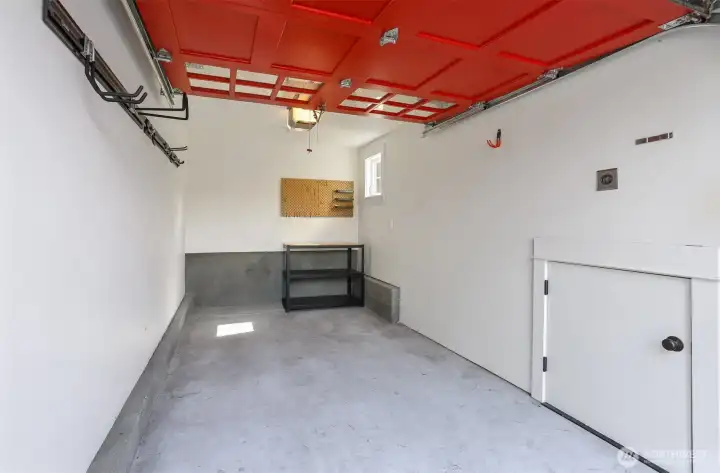 Sweet garage with EV wiring, workbench and additional storage.