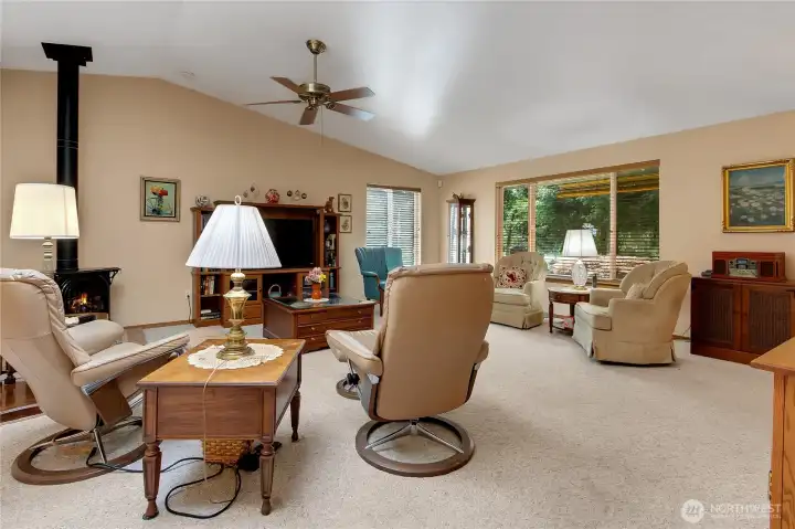 Living room with vaulted ceilings, propane free-standing stove and lots of room