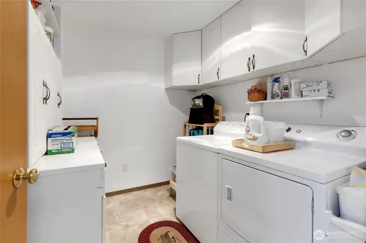 Nice bright laundry room with cabinets