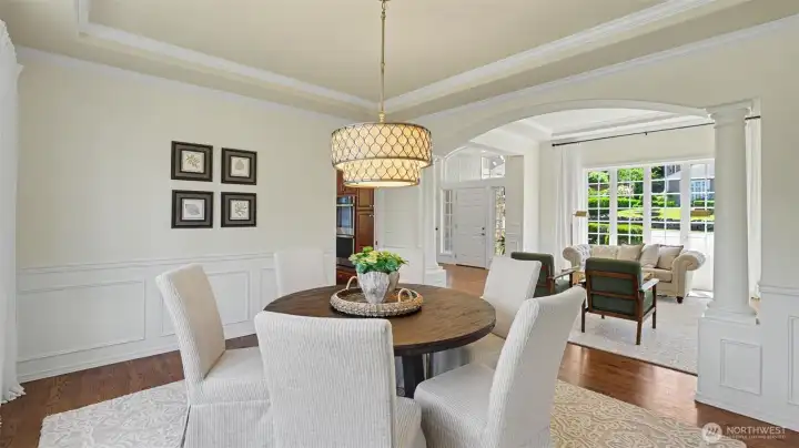 Wainscot and inlayed crown molding continue into the formal dining area, giving a polished and cohesive feel. Wainscot and inlayed crown molding continue into the formal dining area, giving a polished and cohesive feel.
