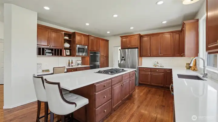 GE Profile double-oven & dishwasher, Samsung refrigerator, oversized stainless steel sink, and expansive island with tons of storage! Don't miss the built-in desk area that is perfect for meal-planning, studying, or organizing household affairs. GE Profile double-oven & dishwasher, Samsung refrigerator, oversized stainless steel sink, and expansive island with tons of storage! Don't miss the built-in desk area that is perfect for meal-planning, studying, or organizing household affairs.