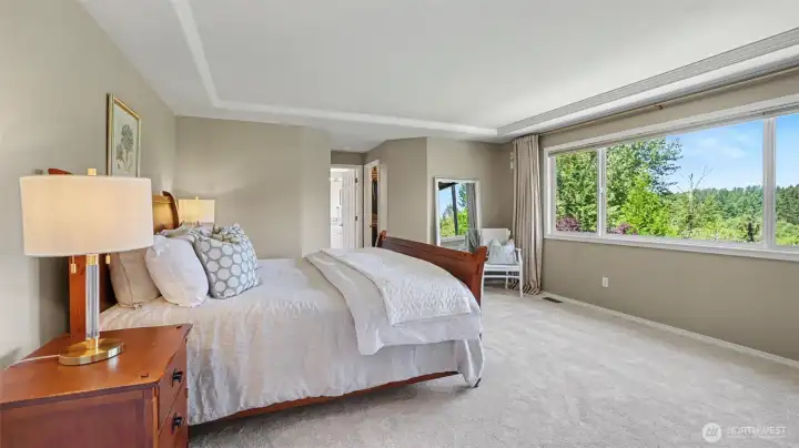 The upstairs primary suite with coffered ceiling and bank of windows overlooks the private and serene backyard. The upstairs primary suite with coffered ceiling and bank of windows overlooks the private and serene backyard.
