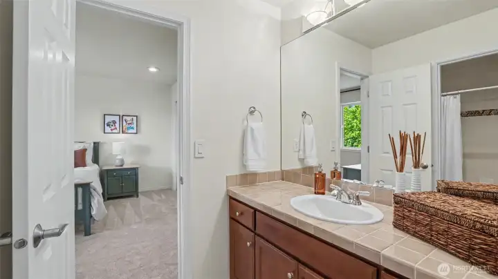 Jack-and-Jill bedrooms share this secondary full bathroom which features updated vinyl plank flooring. Jack-and-Jill bedrooms share this secondary full bathroom which features updated vinyl plank flooring.