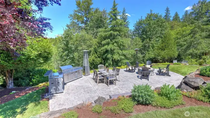 Stamped concrete patio features a fire pit and electrical outlet for convenience. Stamped concrete patio features a fire pit and electrical outlet for convenience.