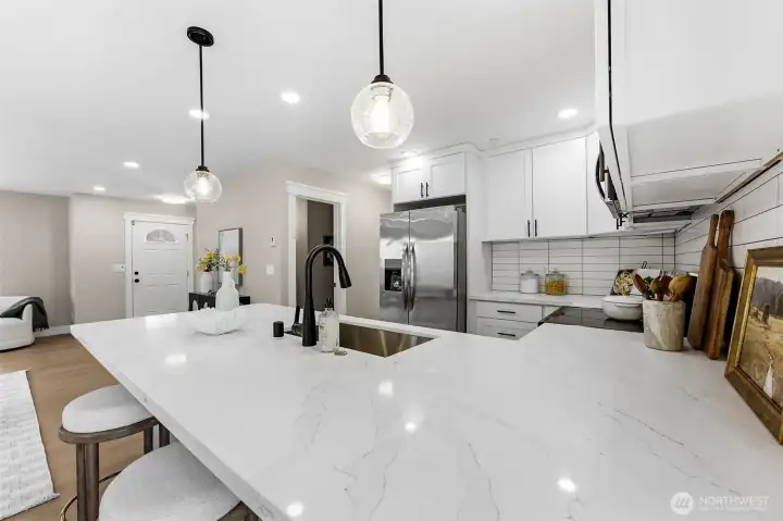 New quartz countertops and lighting in kitchen.