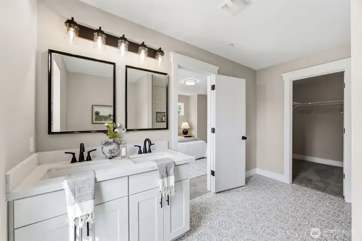 Primary en suite bathroom with double vanity.