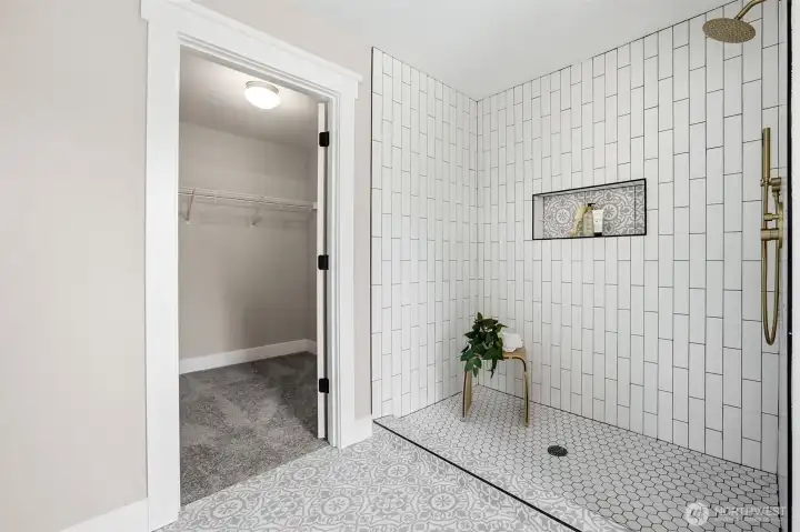 New shower with tile and modern fixtures in primary bathroom.
