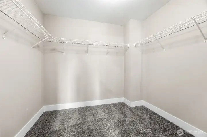 Walk in closet off of bathroom in primary suite