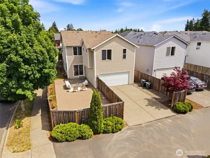 Birdseye view from the back with view of garage and fenced patio