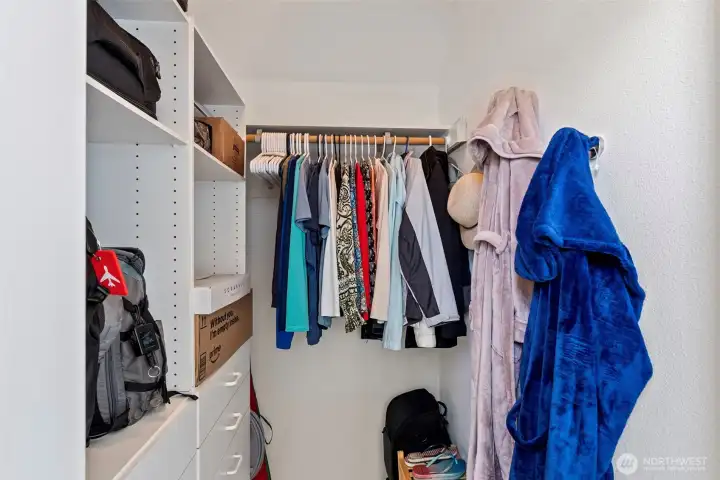 Primary walk-in closet with closet storage system.