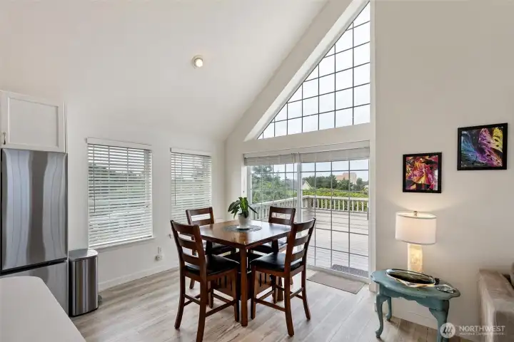 Eat-in kitchen space with sliding glass door leading to the wrap around deck.