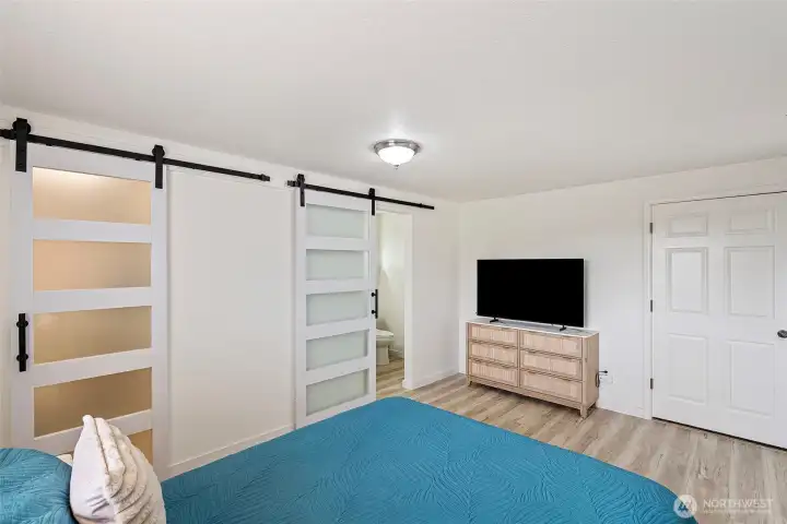 Lower level bedroom suite with walk-in closet and private exit through garage.