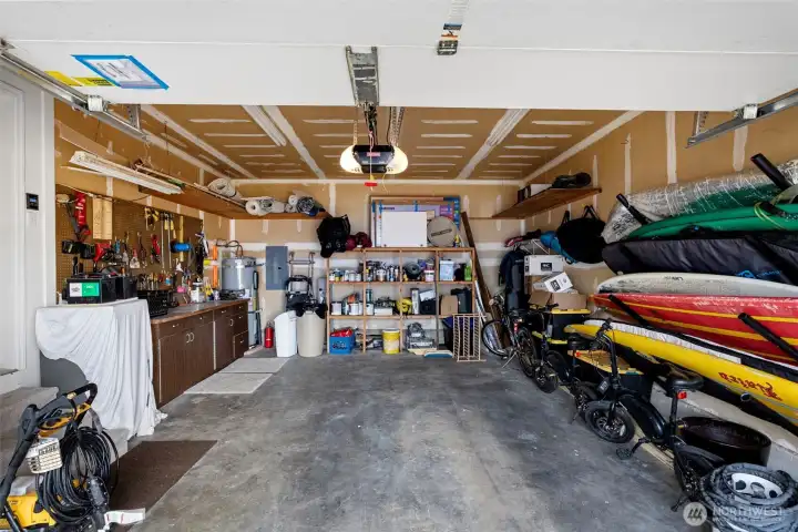 384 sqft oversized garage with shelving and storage and lower level entry.