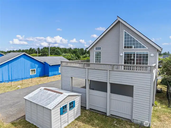 Outbuilding, deck, 10ft tall covered parking.