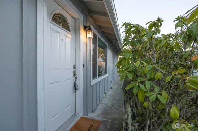 Looking at the front entry with the sidewalk leading toward the alley.