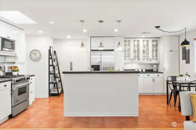 large kitchen with island and gas range