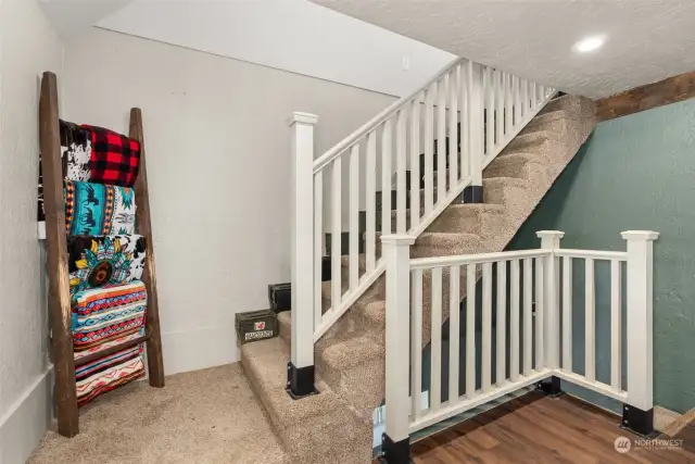 Stairs to primary bedroom, and lower level