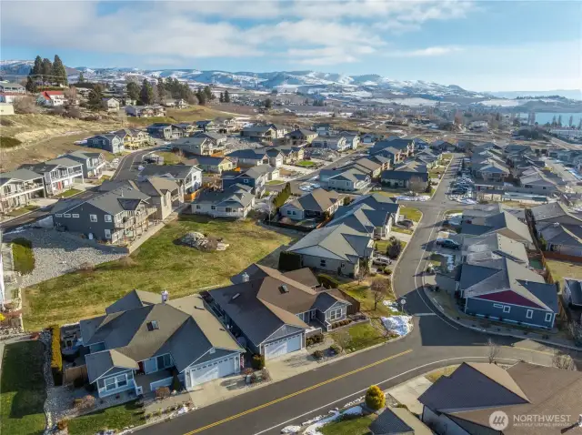 This residence backs lush green grass open space for the community.