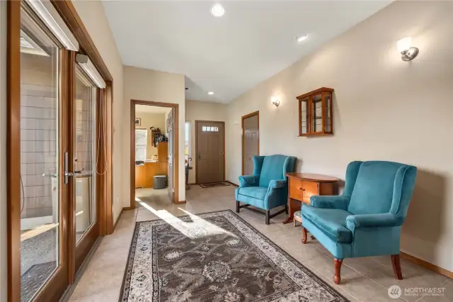 Entry seating looking and fenced side yard and patio.