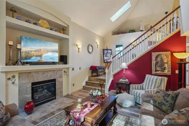 Living room with open staircase up stairs.