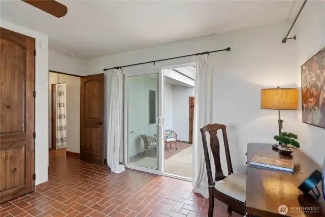 Bedroom with doors to private patio.