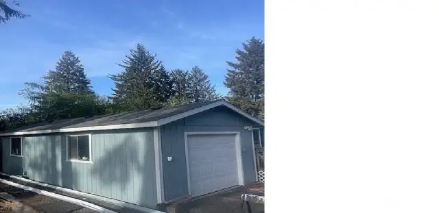 Another view of garage  New roof and gutters have been installed.