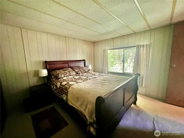 Primary bedroom is spacious with a wall of closets
